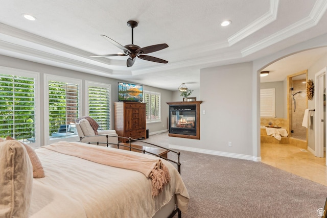 10921 S Renengade View Ln W, South Jordan, UT 84095 - bedroom with crown molding, carpet flooring, a tray ceiling, arched walkways, and a multi sided fireplace