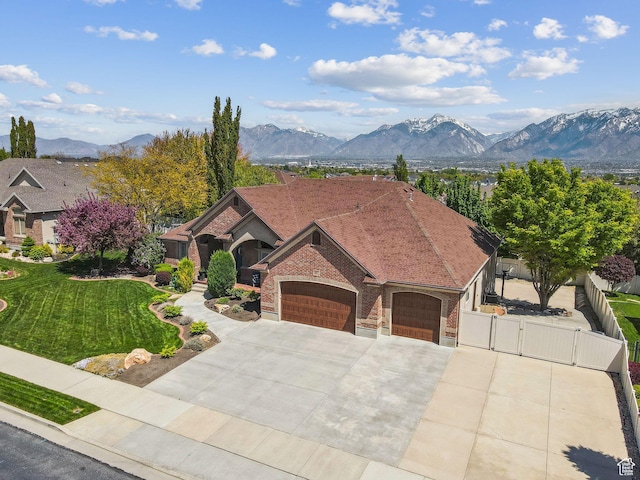 10921 S Renengade View Ln W, South Jordan, UT 84095 - view of front of property with a front lawn, fence, a gate, concrete driveway, and an attached garage