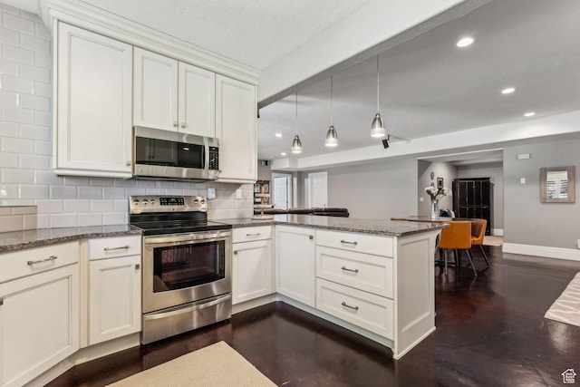 10921 S Renengade View Ln W, South Jordan, UT 84095 - kitchen with backsplash, light stone counters, a peninsula, stainless steel appliances, and recessed lighting