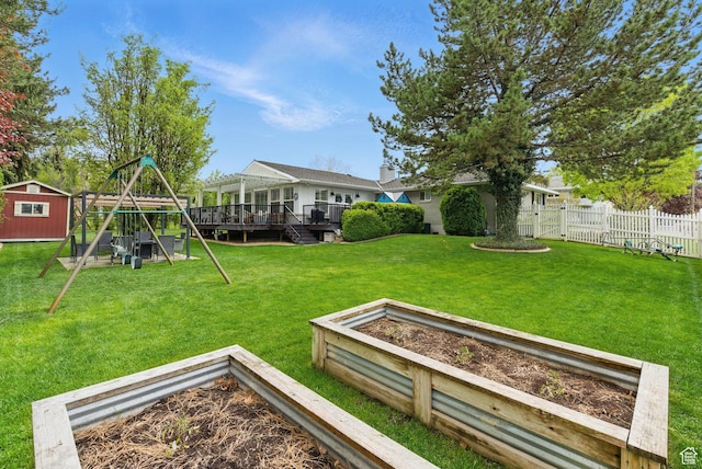 15 S 300 E, Payson, UT 84651 - view of yard featuring fence, a storage shed, a deck, a vegetable garden, and a playground