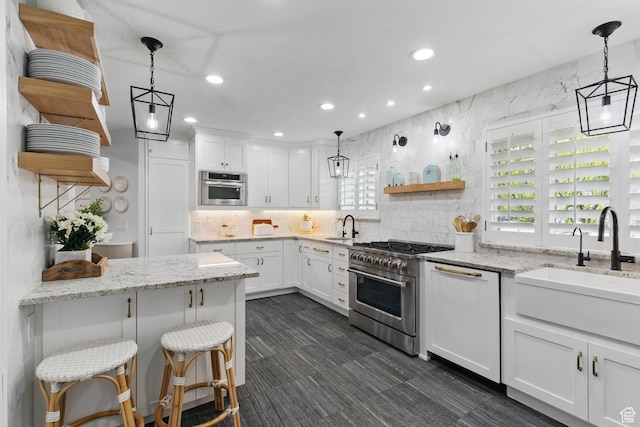 15 S 300 E, Payson, UT 84651 - kitchen featuring open shelves, a sink, decorative backsplash, and appliances with stainless steel finishes