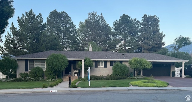 15 S 300 E, Payson, UT 84651 - ranch-style house with a garage, a front yard, a chimney, driveway, and brick siding