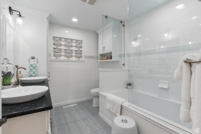 15 S 300 E, Payson, UT 84651 - full bathroom featuring double vanity, tile walls, tile patterned flooring, a sink, and toilet