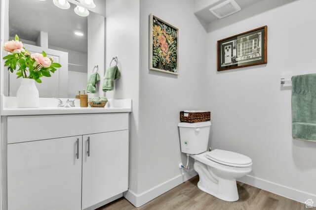 1140 W 950 N Unit E202, Orem, UT 84057 - bathroom featuring baseboards, wood finished floors, toilet, and vanity