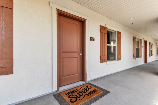 1140 W 950 N Unit E202, Orem, UT 84057 - doorway to property featuring stucco siding and covered porch