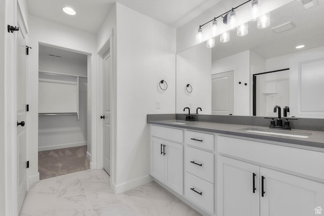 6621 W Spring Snow Ln, Herriman, UT 84096 - bathroom featuring double vanity, marble finish flooring, a walk in closet, recessed lighting, and a shower