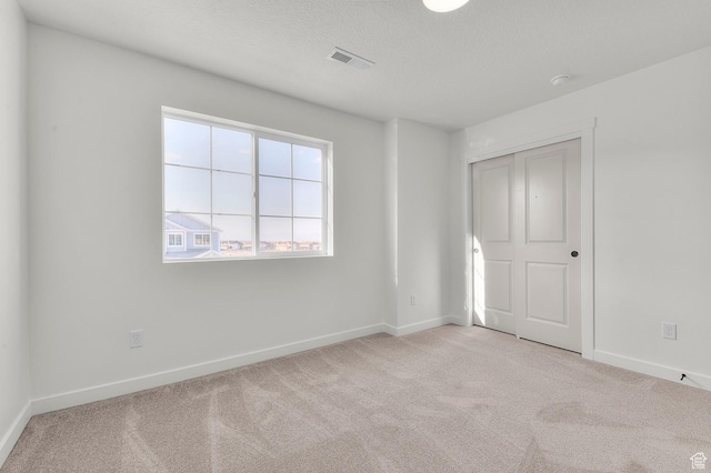 6621 W Spring Snow Ln, Herriman, UT 84096 - unfurnished bedroom featuring light carpet and a closet