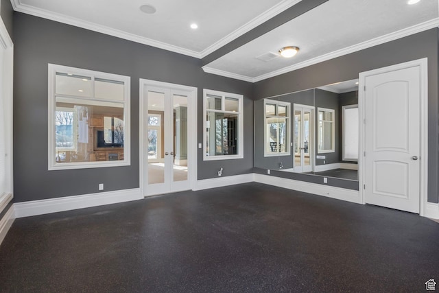 spare room with crown molding, baseboards, visible vents, and french doors