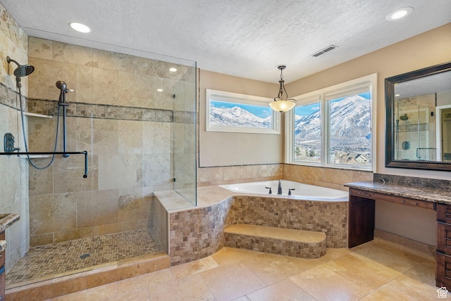 bathroom featuring a bath, tiled shower, a textured ceiling, and visible vents