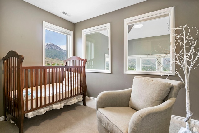 bedroom with baseboards, carpet flooring, visible vents, and multiple windows