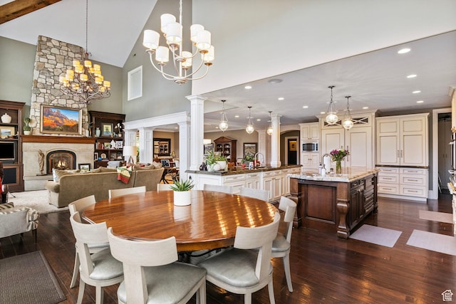 dining space featuring recessed lighting, high vaulted ceiling, dark wood-style floors, and a notable chandelier
