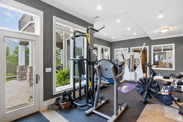 exercise room with recessed lighting, ornamental molding, a wealth of natural light, and visible vents