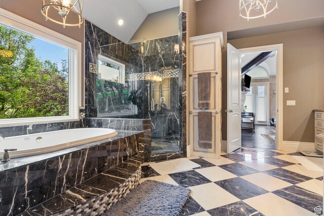 full bathroom featuring an inviting chandelier, a marble finish shower, plenty of natural light, and a bath