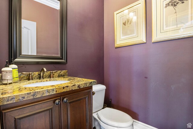 bathroom featuring toilet and vanity
