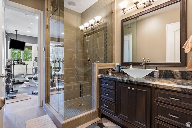 bathroom with a shower stall and vanity