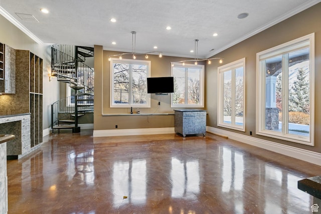 unfurnished living room with crown molding, a premium fireplace, baseboards, and stairway