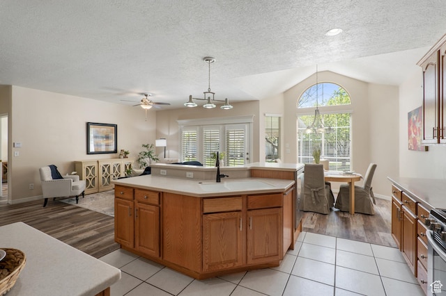 1139 Grainery Cv, Riverton, UT 84065 - kitchen featuring light wood-style floors, open floor plan, lofted ceiling, and light countertops