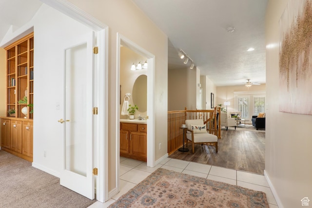 1139 Grainery Cv, Riverton, UT 84065 - corridor with light tile patterned floors, baseboards, and a sink