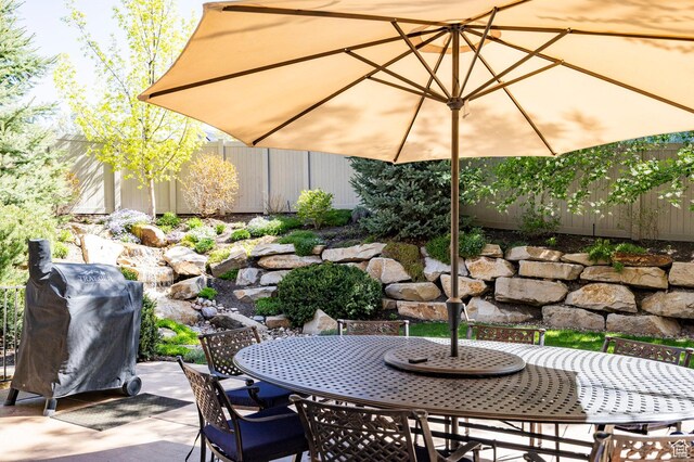 8777 S Falcon Heights Ln E, Cottonwood Heights, UT 84093 - view of patio with fence, outdoor dining area, and grilling area
