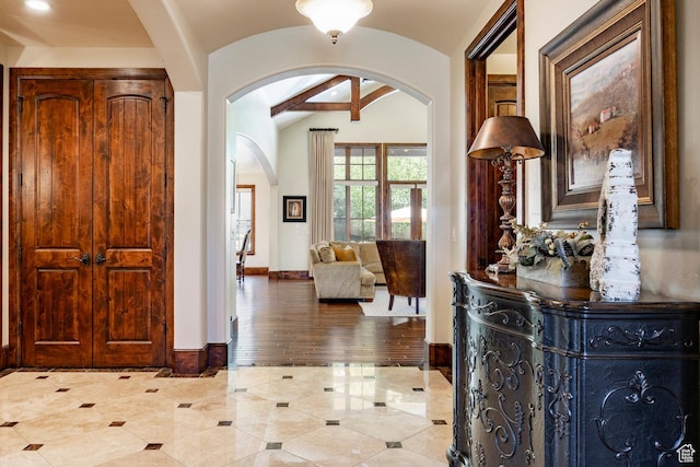 8777 S Falcon Heights Ln E, Cottonwood Heights, UT 84093 - entryway featuring arched walkways, baseboards, vaulted ceiling, and light tile patterned floors