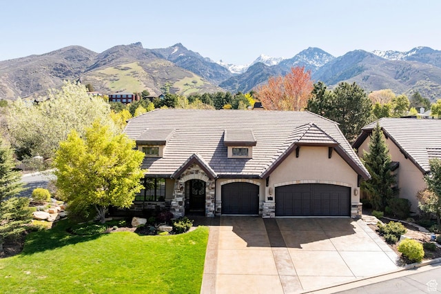 8777 S Falcon Heights Ln E, Cottonwood Heights, UT 84093 - tudor-style house with a front yard, stone siding, stucco siding, concrete driveway, and an attached garage