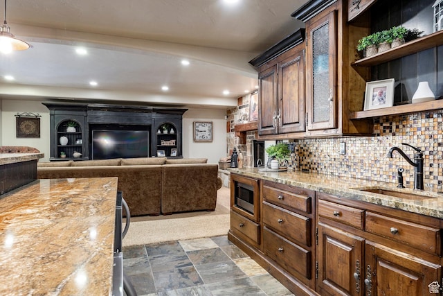 8777 S Falcon Heights Ln E, Cottonwood Heights, UT 84093 - kitchen featuring open shelves, light stone counters, a sink, built in microwave, and decorative backsplash