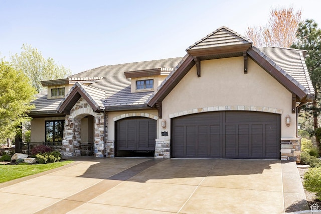 8777 S Falcon Heights Ln E, Cottonwood Heights, UT 84093 - view of front of house with an attached garage, driveway, stone siding, and stucco siding