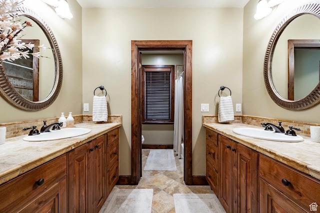 8777 S Falcon Heights Ln E, Cottonwood Heights, UT 84093 - full bathroom with vanity, decorative backsplash, baseboards, and toilet