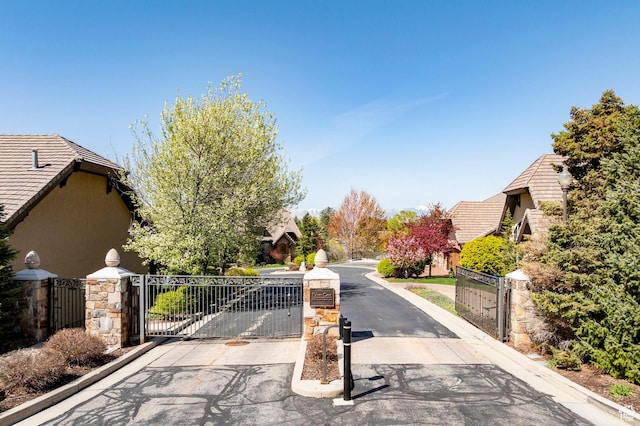 8777 S Falcon Heights Ln E, Cottonwood Heights, UT 84093 - view of road featuring a gate, a gated entry, and curbs