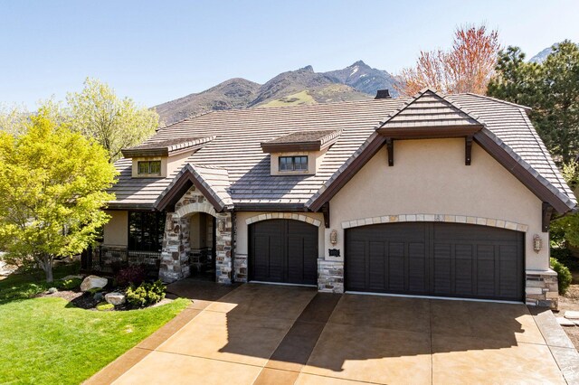 8777 S Falcon Heights Ln E, Cottonwood Heights, UT 84093 - view of front of house with an attached garage, stucco siding, stone siding, and concrete driveway