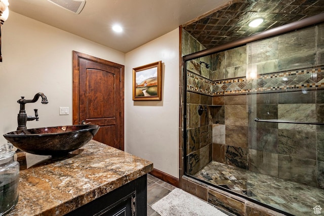 8777 S Falcon Heights Ln E, Cottonwood Heights, UT 84093 - bathroom with visible vents, baseboards, a stall shower, and vanity
