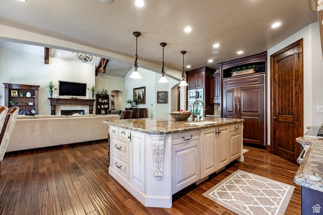 8777 S Falcon Heights Ln E, Cottonwood Heights, UT 84093 - kitchen featuring white cabinets, light stone countertops, a sink, built in appliances, and dark wood finished floors