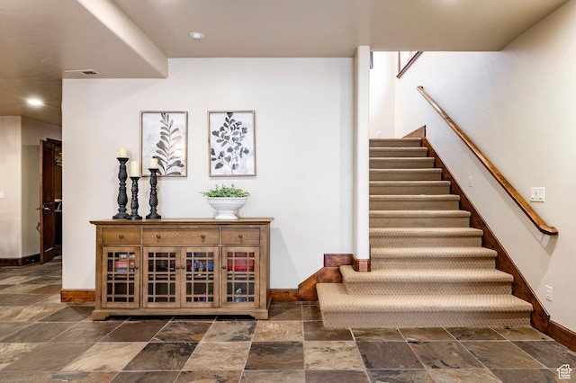8777 S Falcon Heights Ln E, Cottonwood Heights, UT 84093 - stairway with baseboards, stone tile floors, visible vents, and recessed lighting