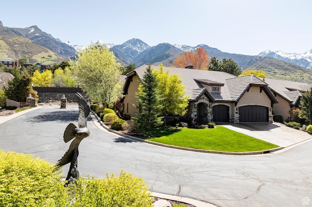 8777 S Falcon Heights Ln E, Cottonwood Heights, UT 84093 - view of front of house with a front yard, a mountain view, stone siding, and stucco siding