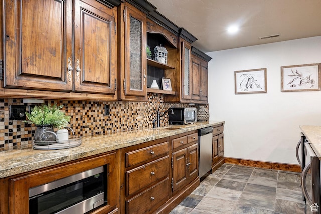 8777 S Falcon Heights Ln E, Cottonwood Heights, UT 84093 - kitchen with decorative backsplash, light stone countertops, glass insert cabinets, baseboards, and appliances with stainless steel finishes