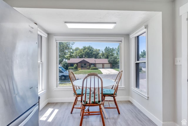 84 W Wasatch St S, Midvale, UT 84047 - dining space with baseboards, light wood-type flooring, and a wealth of natural light