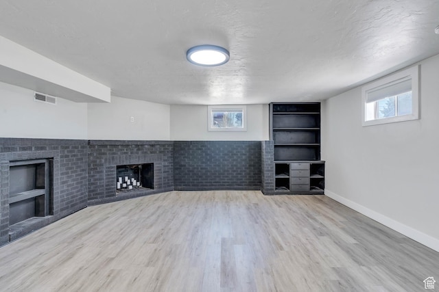 84 W Wasatch St S, Midvale, UT 84047 - unfurnished living room with visible vents, a fireplace, a healthy amount of sunlight, and built in shelves
