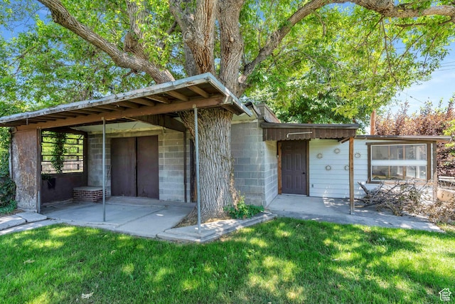 84 W Wasatch St S, Midvale, UT 84047 - exterior space featuring concrete block siding, a patio area, and a front lawn