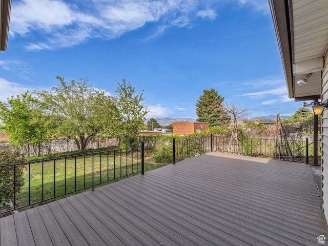 5362 W Elaine Ave, West Valley City, UT 84120 - wooden deck with a lawn and a fenced backyard