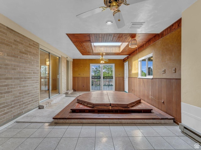 5362 W Elaine Ave, West Valley City, UT 84120 - interior space featuring wood walls, a wainscoted wall, a ceiling fan, a baseboard radiator, and visible vents