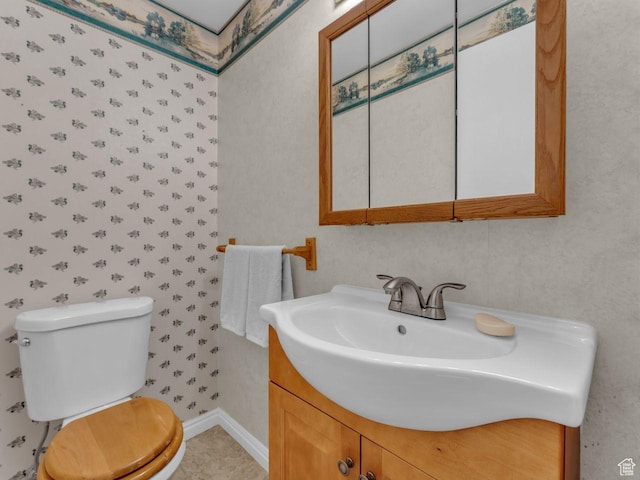 5362 W Elaine Ave, West Valley City, UT 84120 - bathroom with vanity, baseboards, wallpapered walls, and toilet