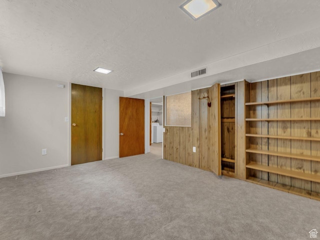 5362 W Elaine Ave, West Valley City, UT 84120 - finished below grade area with visible vents, carpet, a textured ceiling, and wooden walls