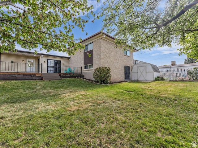5362 W Elaine Ave, West Valley City, UT 84120 - rear view of house with an outdoor structure, a lawn, a storage shed, and brick siding