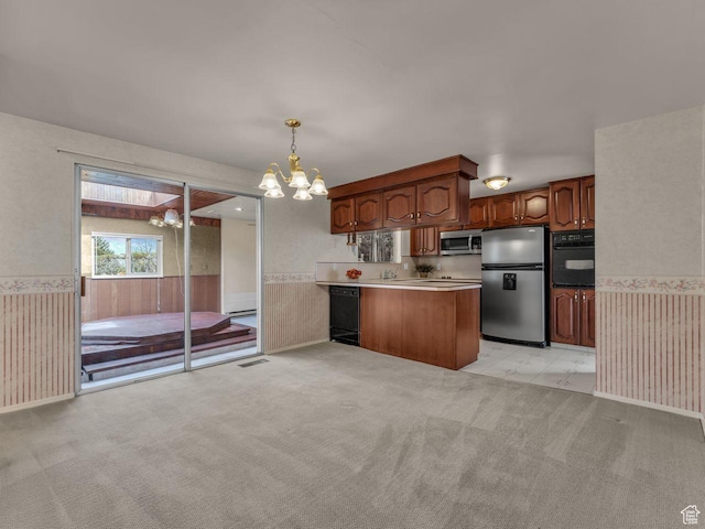 5362 W Elaine Ave, West Valley City, UT 84120 - kitchen with wainscoting, a peninsula, light colored carpet, a chandelier, and black appliances