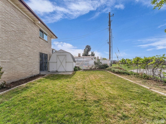 5362 W Elaine Ave, West Valley City, UT 84120 - view of yard with an outbuilding, fence, and a storage shed