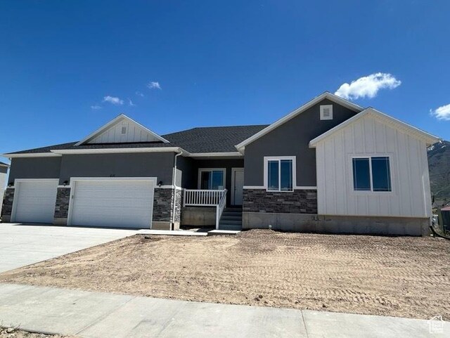 438 N 500 E Lot 2, Salem, UT 84653 - view of front facade featuring an attached garage, stone siding, board and batten siding, a porch, and driveway