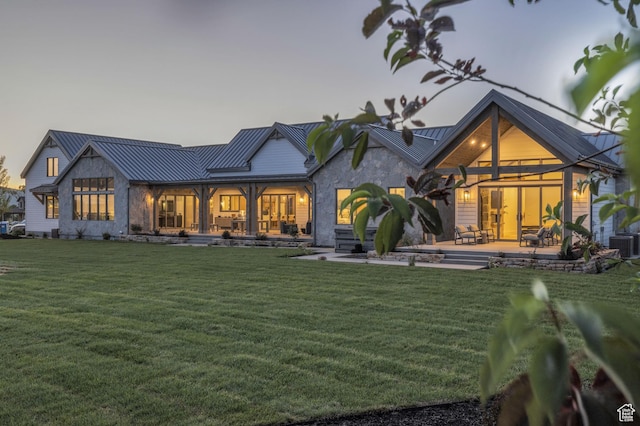 205 W Lazy Acres Ln, Kamas, UT 84036 - rear view of house featuring a lawn, stone siding, and a standing seam roof