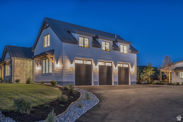 205 W Lazy Acres Ln, Kamas, UT 84036 - view of front of property featuring an attached garage, a standing seam roof, a yard, driveway, and metal roof