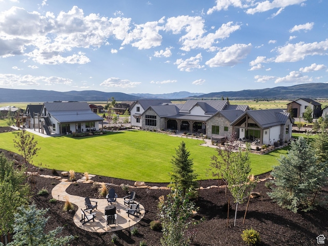 205 W Lazy Acres Ln, Kamas, UT 84036 - rear view of property with a lawn, a fire pit, and a mountain view