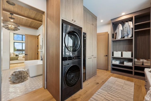 205 W Lazy Acres Ln, Kamas, UT 84036 - clothes washing area featuring light wood-style flooring, stacked washing maching and dryer, and wooden ceiling
